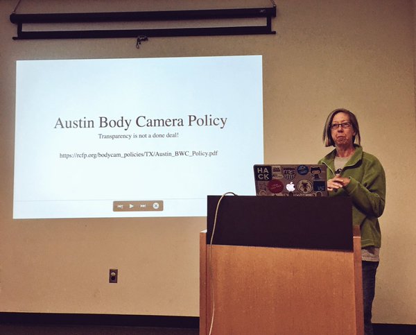 Kathy Mitchell speaks in front of slideshow projection